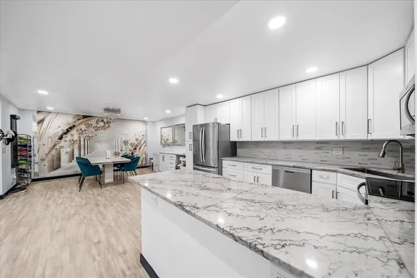 a kitchen with stainless steel appliances granite countertop a sink stove and refrigerator