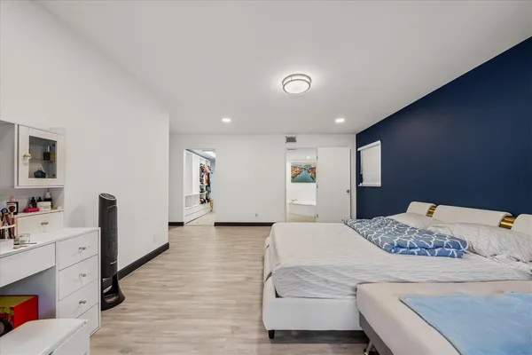 a bedroom with a bed and a dresser