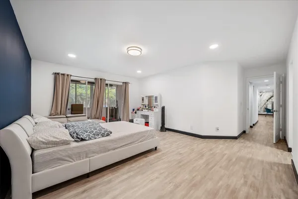 a living room with a bed furniture and next to a window