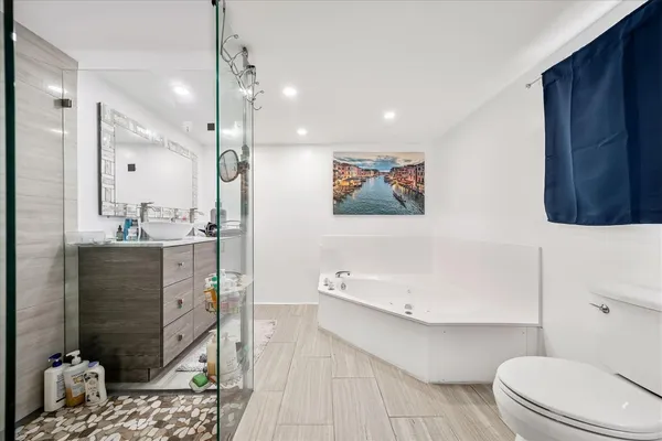 a bathroom with a sink a toilet and shower