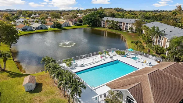 an aerial view of a house with a garden and lake view