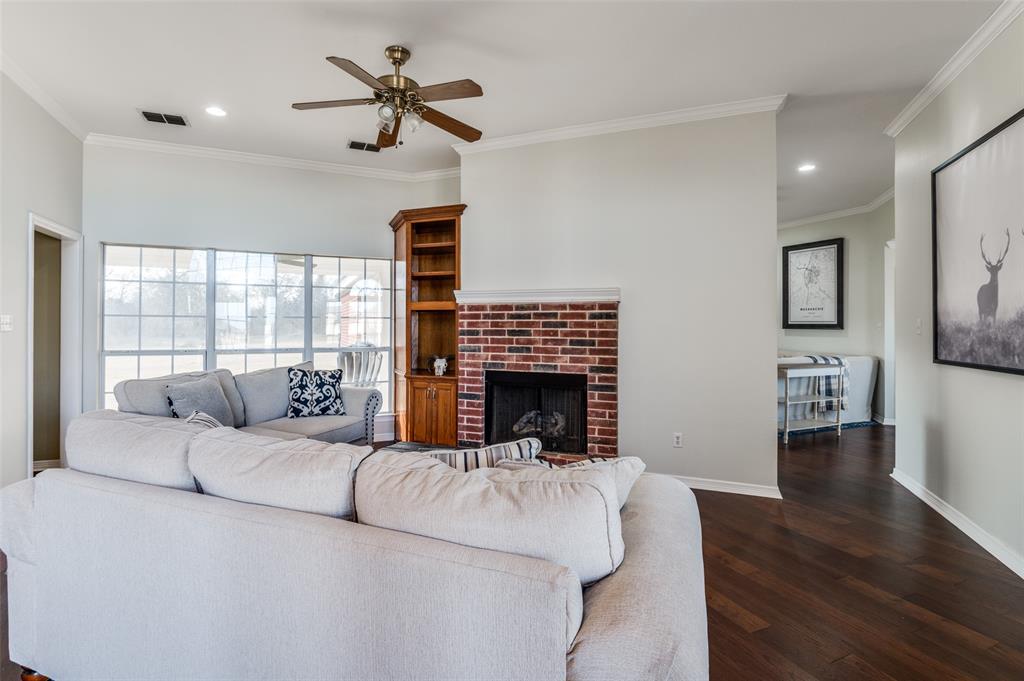 168 Hunters Glen Waxahachie, TX 75167 - Photo 7 of 29 a living room with fireplace furniture and a wooden floor