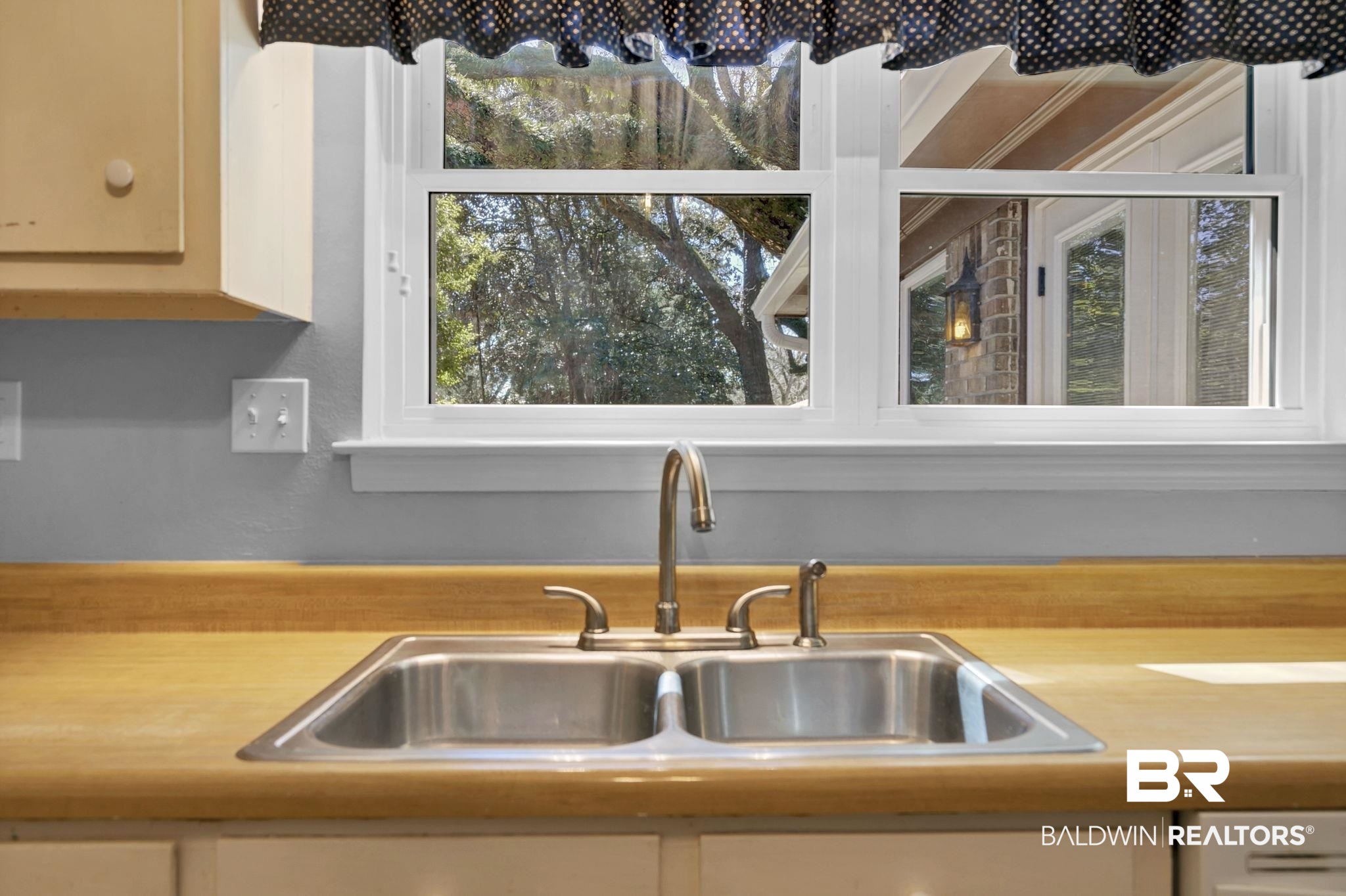 5817 Woodgate Road Mobile, AL 36609 - Photo 23 of 85 Room details featuring white cabinets, light countertops, and a sink