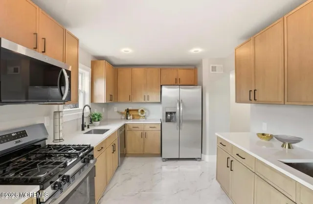 a kitchen with a sink a stove and refrigerator