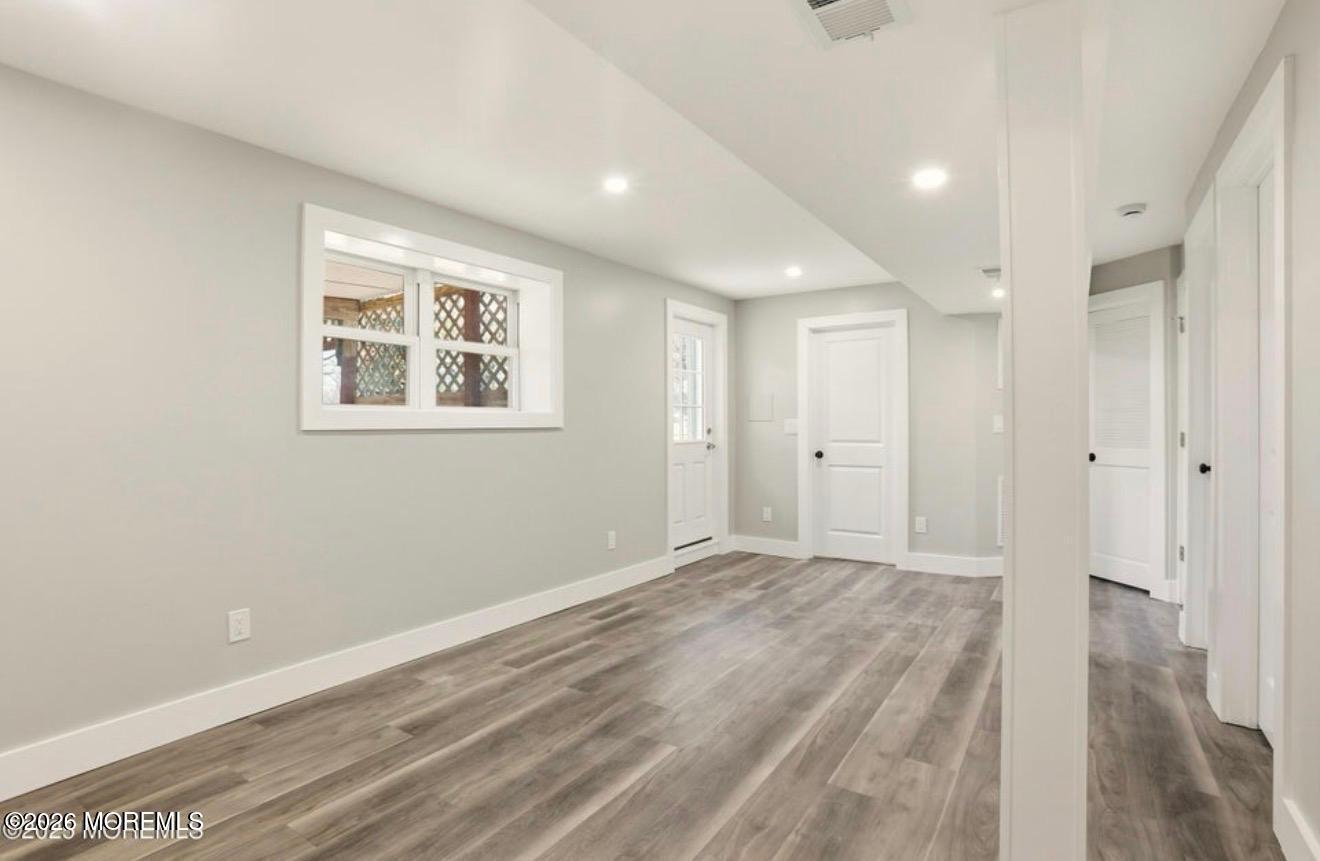 112 Manhattan Street Jackson, NJ 08527 - Photo 25 of 41 a view of an empty room with wooden floor and a window
