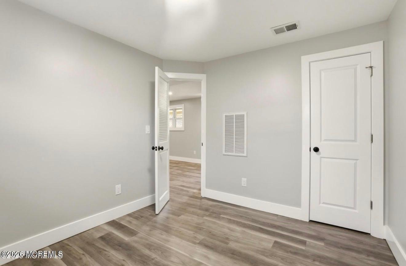 112 Manhattan Street Jackson, NJ 08527 - Photo 27 of 41 an empty room with wooden floor and windows