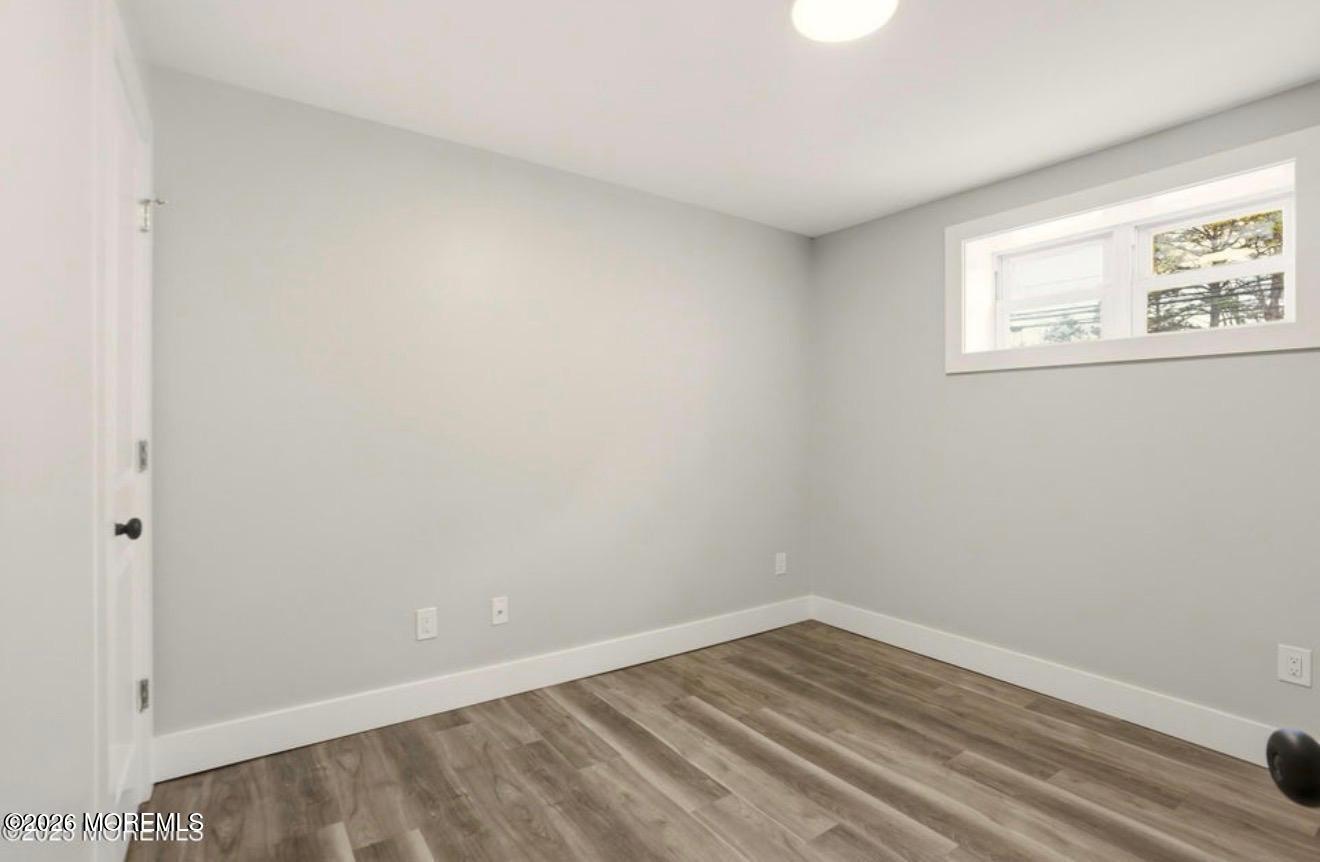 112 Manhattan Street Jackson, NJ 08527 - Photo 28 of 41 a view of an empty room with wooden floor and a window