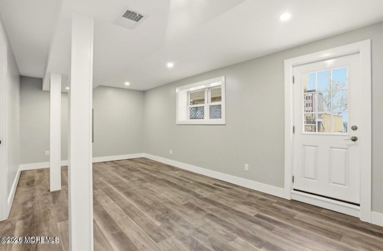 112 Manhattan Street Jackson, NJ 08527 - Photo 31 of 41 a view of an empty room with wooden floor and a window