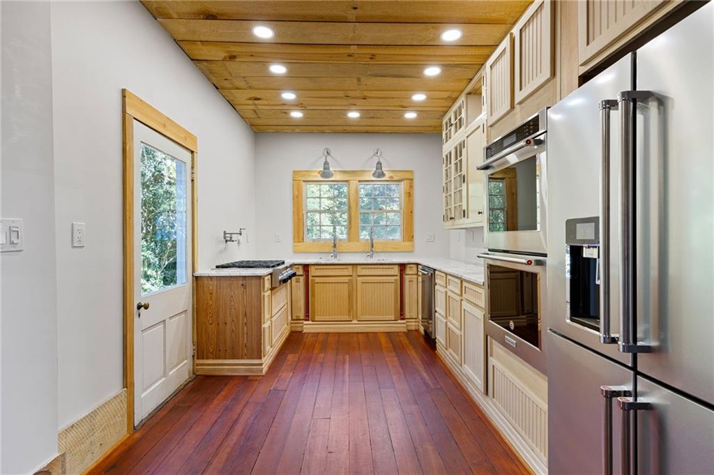 4284 Marietta Street Powder Springs, GA 30127 - Photo 18 of 70 a kitchen with stainless steel appliances a stove a sink and a refrigerator