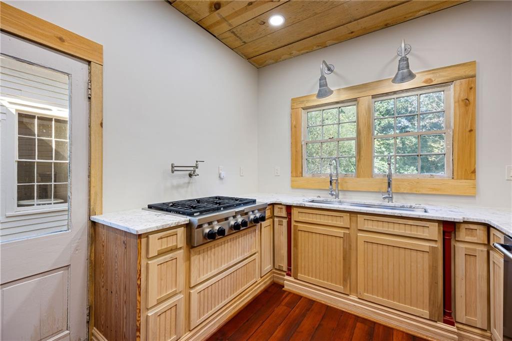 4284 Marietta Street Powder Springs, GA 30127 - Photo 19 of 70 a kitchen with stainless steel appliances granite countertop a stove and a sink