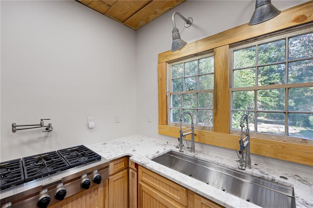 4284 Marietta Street Powder Springs, GA 30127 - Photo 20 of 70 a kitchen with granite countertop a sink and a counter top space