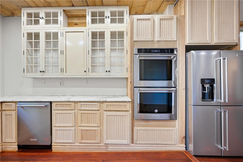 4284 Marietta Street Powder Springs, GA 30127 - Photo 22 of 70 a kitchen with stainless steel appliances granite countertop a stove and a refrigerator