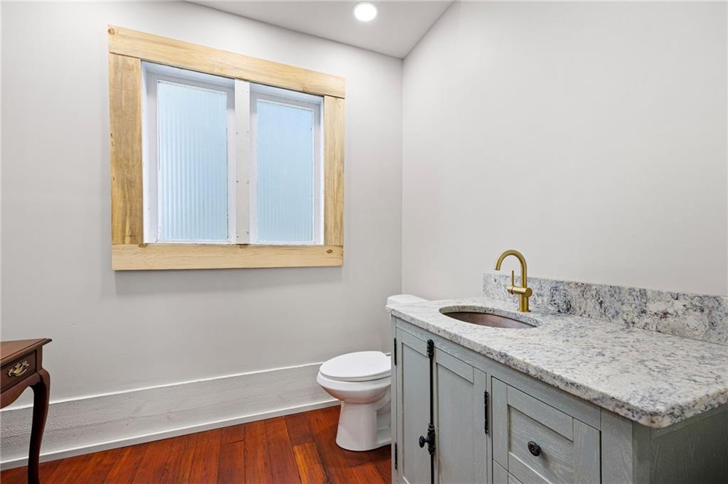 4284 Marietta Street Powder Springs, GA 30127 - Photo 31 of 70 a bathroom with a granite countertop sink toilet and a mirror