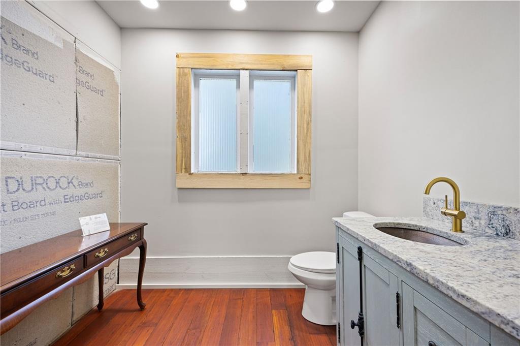 4284 Marietta Street Powder Springs, GA 30127 - Photo 32 of 70 a bathroom with a granite countertop sink toilet a mirror and vanity