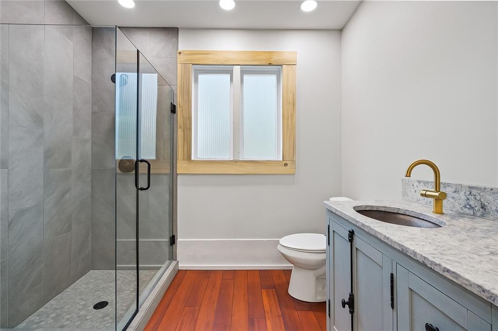 4284 Marietta Street Powder Springs, GA 30127 - Photo 33 of 70 a bathroom with a granite countertop sink a toilet and shower