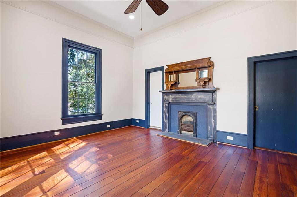4284 Marietta Street Powder Springs, GA 30127 - Photo 37 of 70 a view of an empty room with wooden floor fireplace and a window
