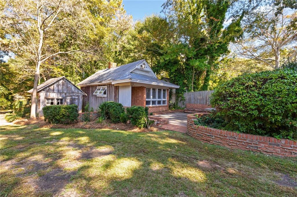 4284 Marietta Street Powder Springs, GA 30127 - Photo 54 of 70 a front view of a house with yard patio and green space