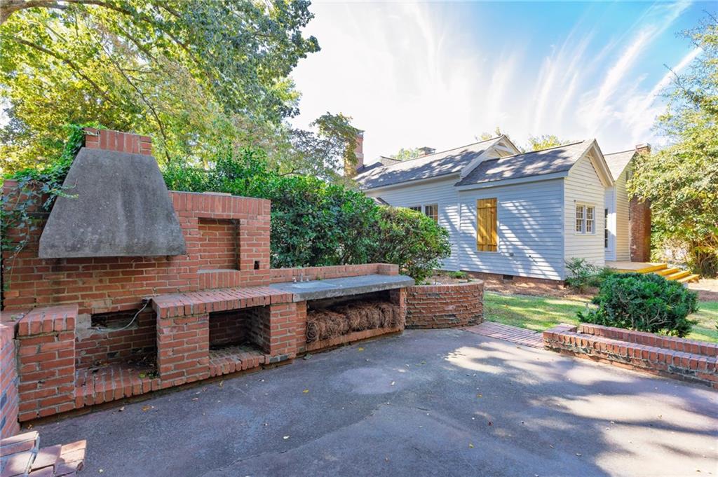 4284 Marietta Street Powder Springs, GA 30127 - Photo 58 of 70 a backyard of a house with a garden and barbeque oven