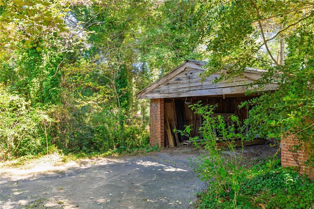 4284 Marietta Street Powder Springs, GA 30127 - Photo 60 of 70 a view of a barn with plants and large trees