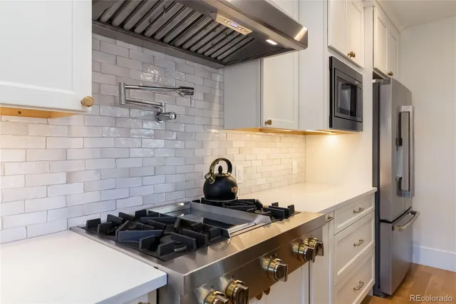 a bedroom with a large bed and a potted plant
