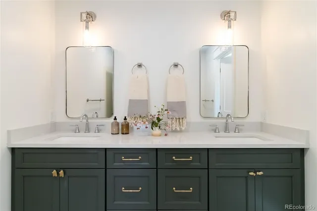 a bathroom with a granite countertop sink a mirror and a shower