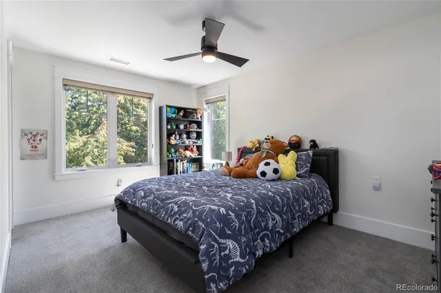 a bed sitting in a bedroom next to a window