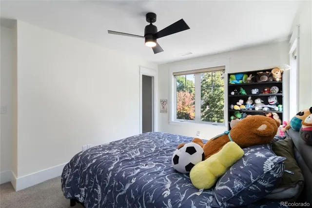 a bedroom with a bed and a large window