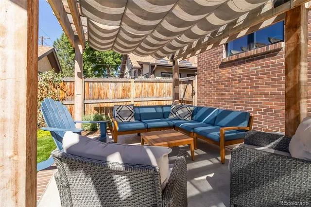 a view of a house with backyard porch and sitting area