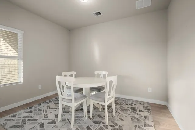 a view of a dining room with furniture and window