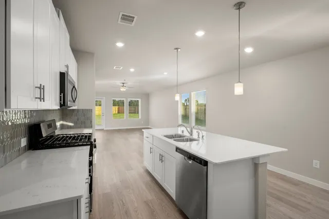 a kitchen with counter top space cabinets and appliances