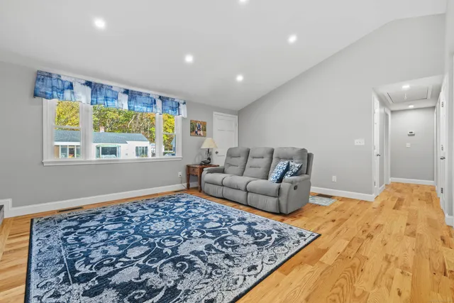 a kitchen with stainless steel appliances granite countertop a table chairs and a refrigerator