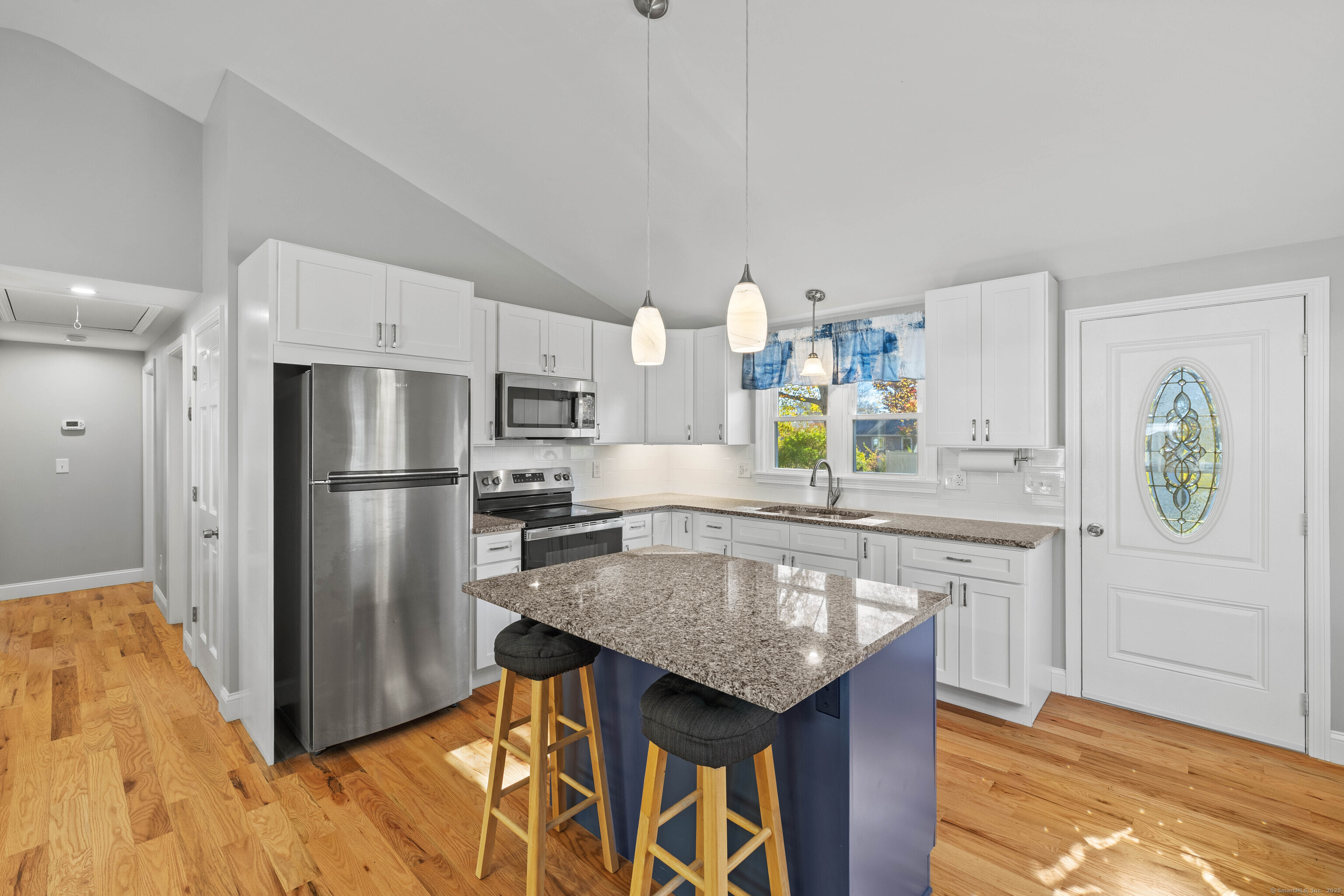 48 Billow Road East Lyme, CT 06357 - Photo 13 of 40 a kitchen with stainless steel appliances granite countertop a table chairs and a refrigerator
