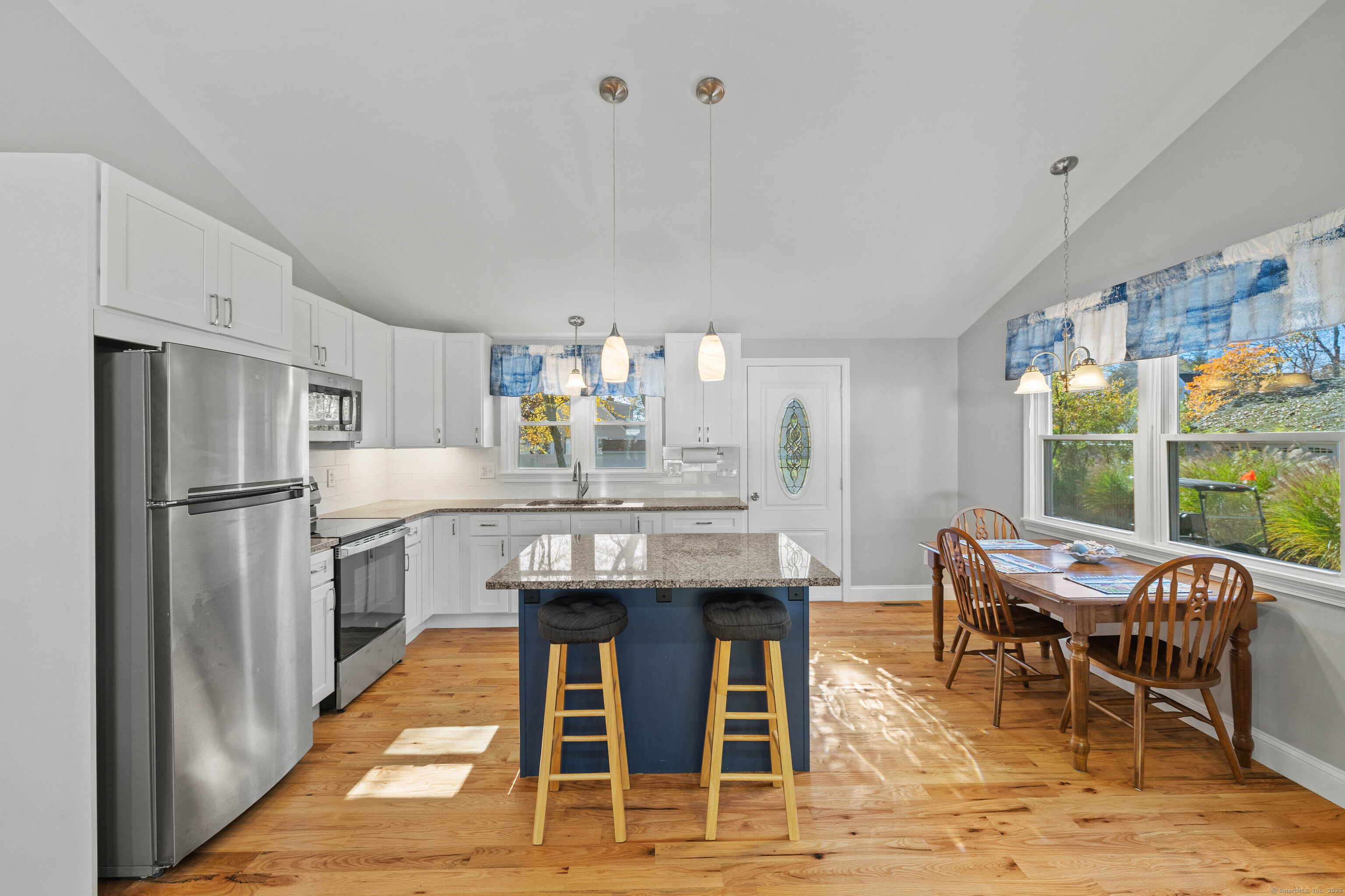 48 Billow Road East Lyme, CT 06357 - Photo 15 of 40 a kitchen with stainless steel appliances kitchen island granite countertop dining table chairs and granite counter tops
