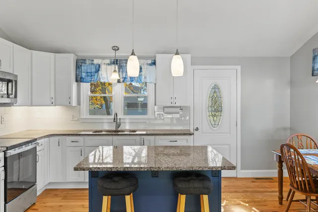 a kitchen with granite countertop a sink and a stove