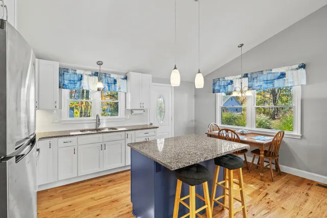 a large kitchen with kitchen island a sink stove and refrigerator