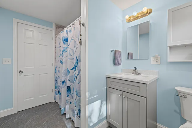 a bathroom with a toilet sink and shower