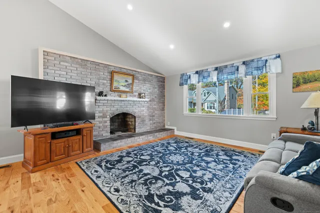 a living room with a flat screen tv and a fireplace