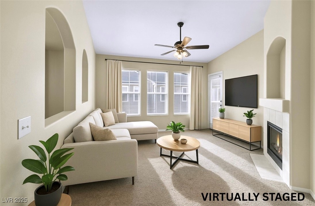 10550 West Alexander Road, Unit 2103 Las Vegas, NV 89129 - Photo 2 of 45 Living area with baseboards, light colored carpet, a fireplace, and ceiling fan