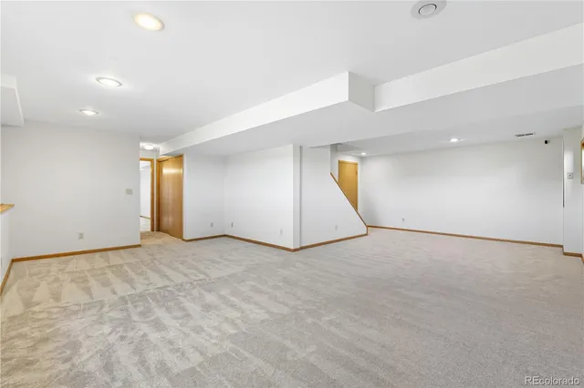 an empty room with a empty space and windows