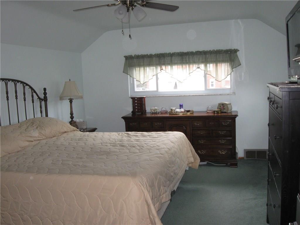 2040 Spring Valley Road Pittsburgh, PA 15243 - Photo 12 of 23 a bedroom with a bed and a chandelier