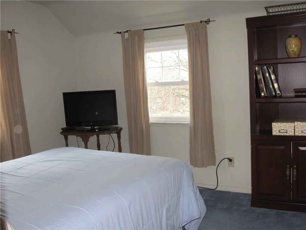 2040 Spring Valley Road Pittsburgh, PA 15243 - Photo 16 of 23 a bedroom with a bed and a flat screen tv