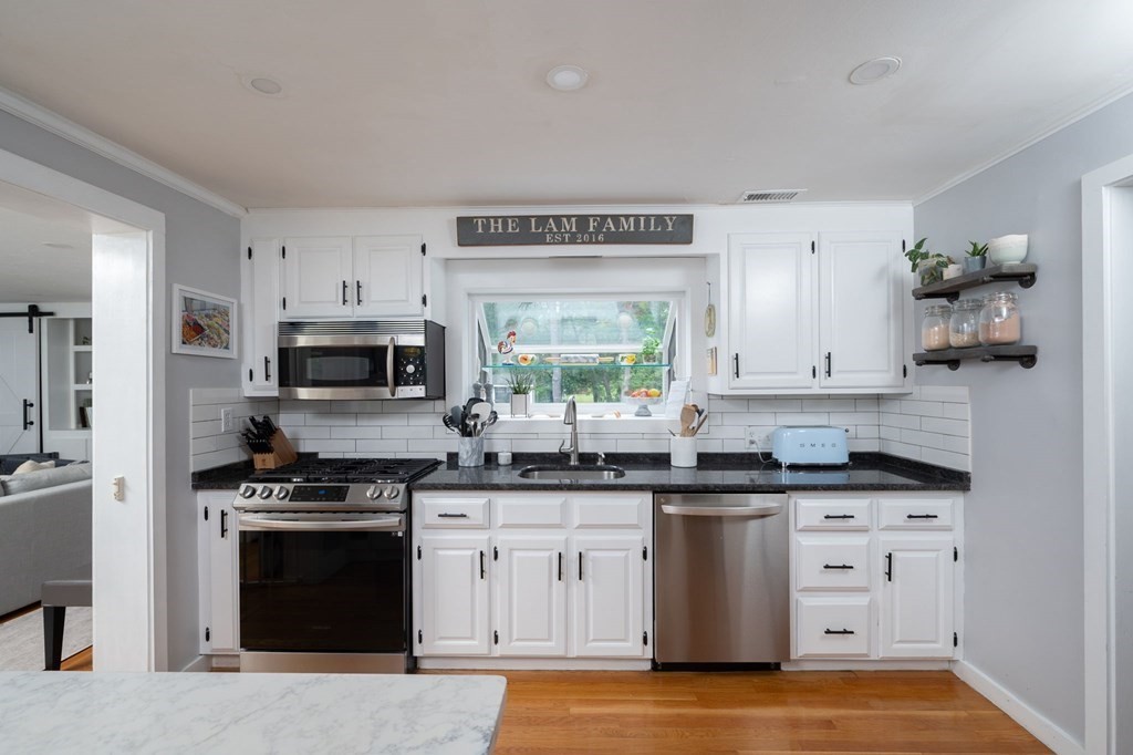 1054 Brook Road Milton, MA 02186 - Photo 5 of 23 a kitchen with stainless steel appliances a stove sink and microwave