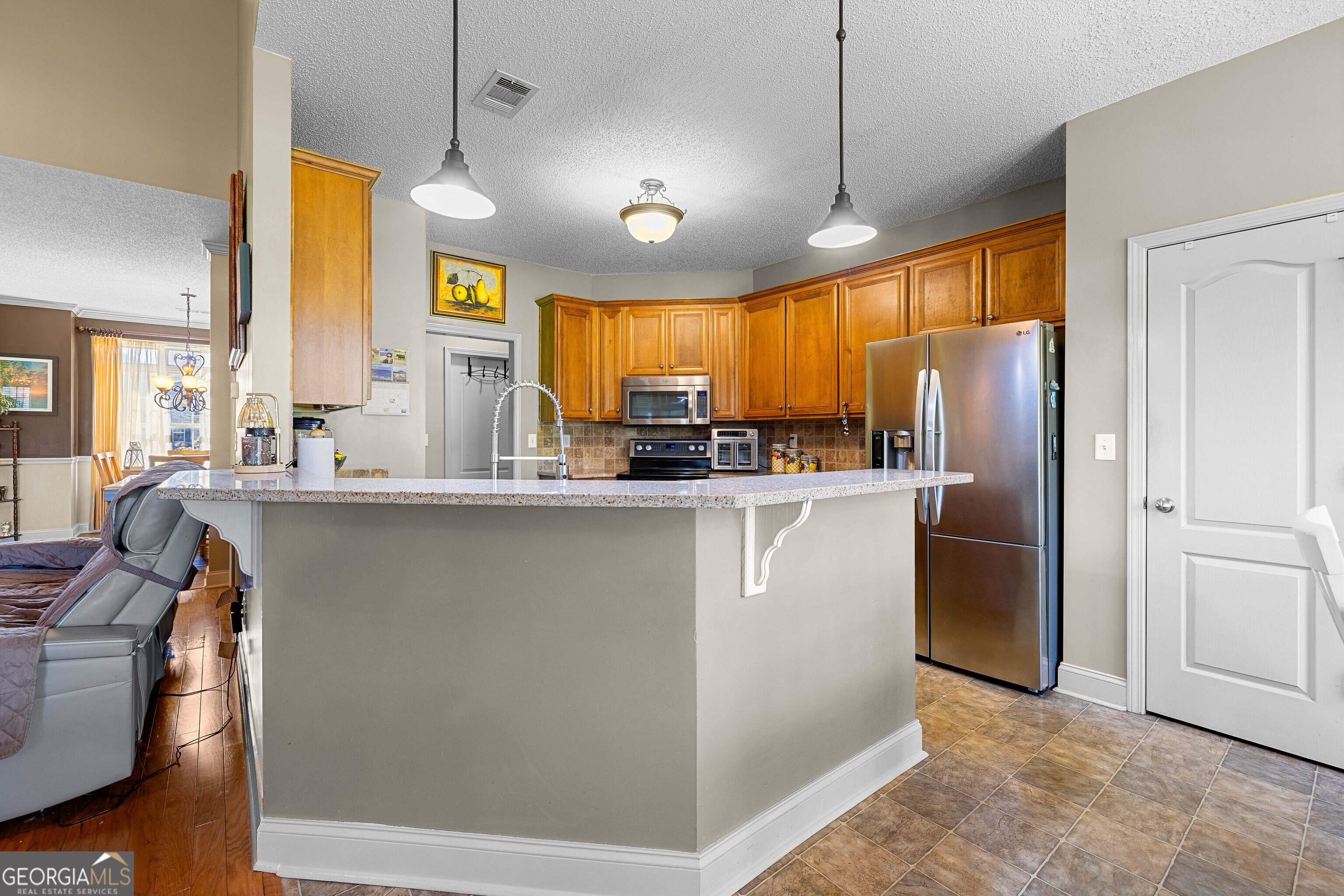 21 Hunters Overlook Drive Senoia, GA 30276 - Photo 11 of 37 a kitchen with refrigerator cabinets and wooden floor