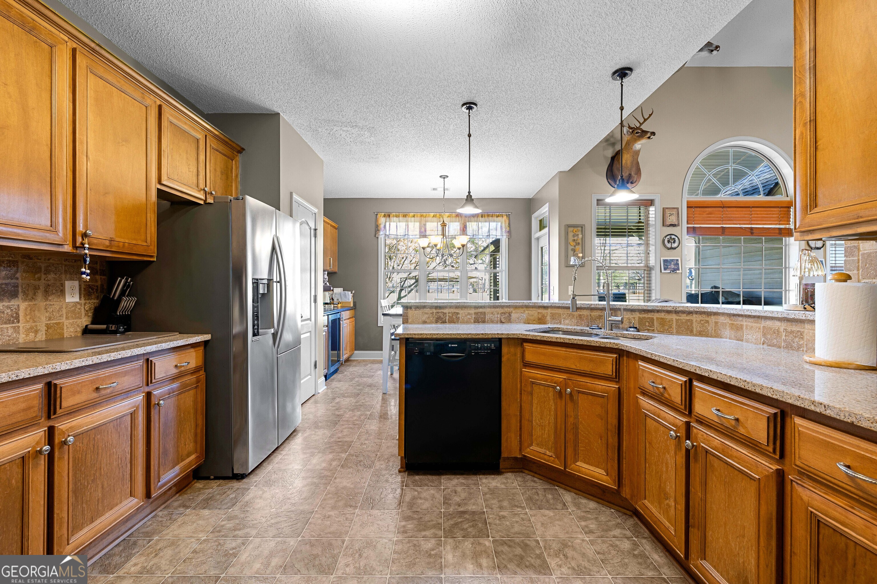 21 Hunters Overlook Drive Senoia, GA 30276 - Photo 14 of 37 a kitchen with stainless steel appliances granite countertop a refrigerator a sink dishwasher a stove and a dining table with wooden floor