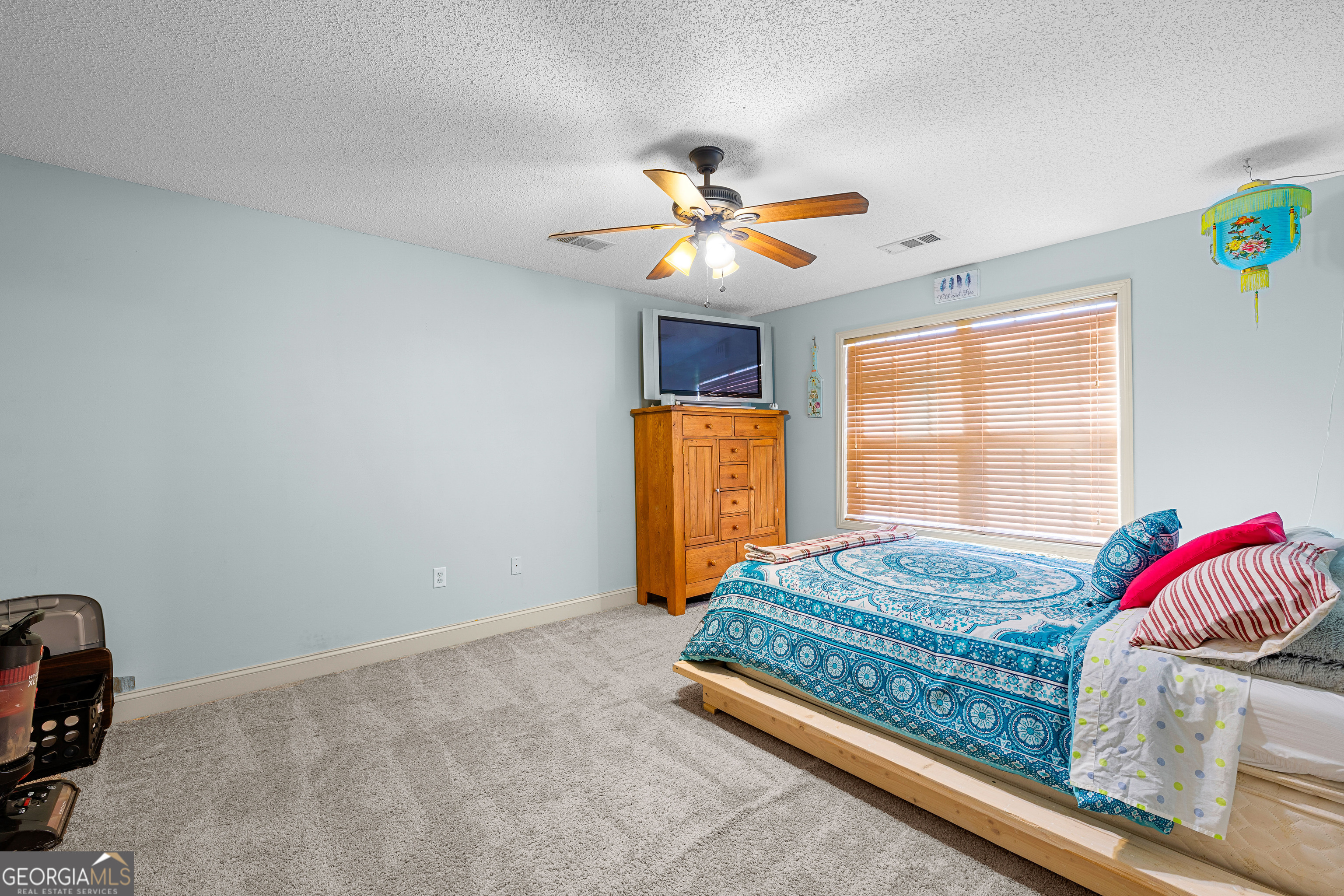 21 Hunters Overlook Drive Senoia, GA 30276 - Photo 20 of 37 a bedroom with a bed and a chandelier