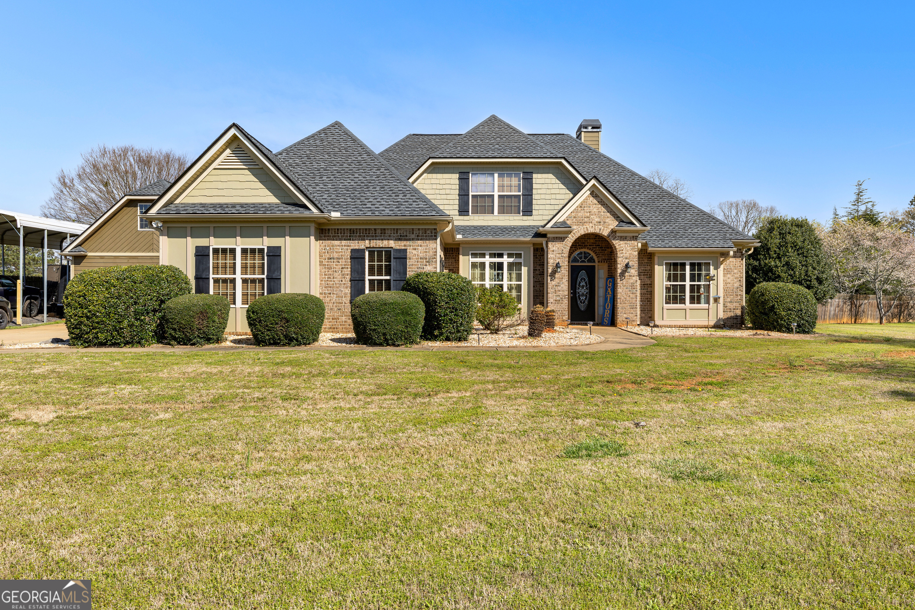 21 Hunters Overlook Drive Senoia, GA 30276 - Photo 2 of 37 a front view of a house with a garden