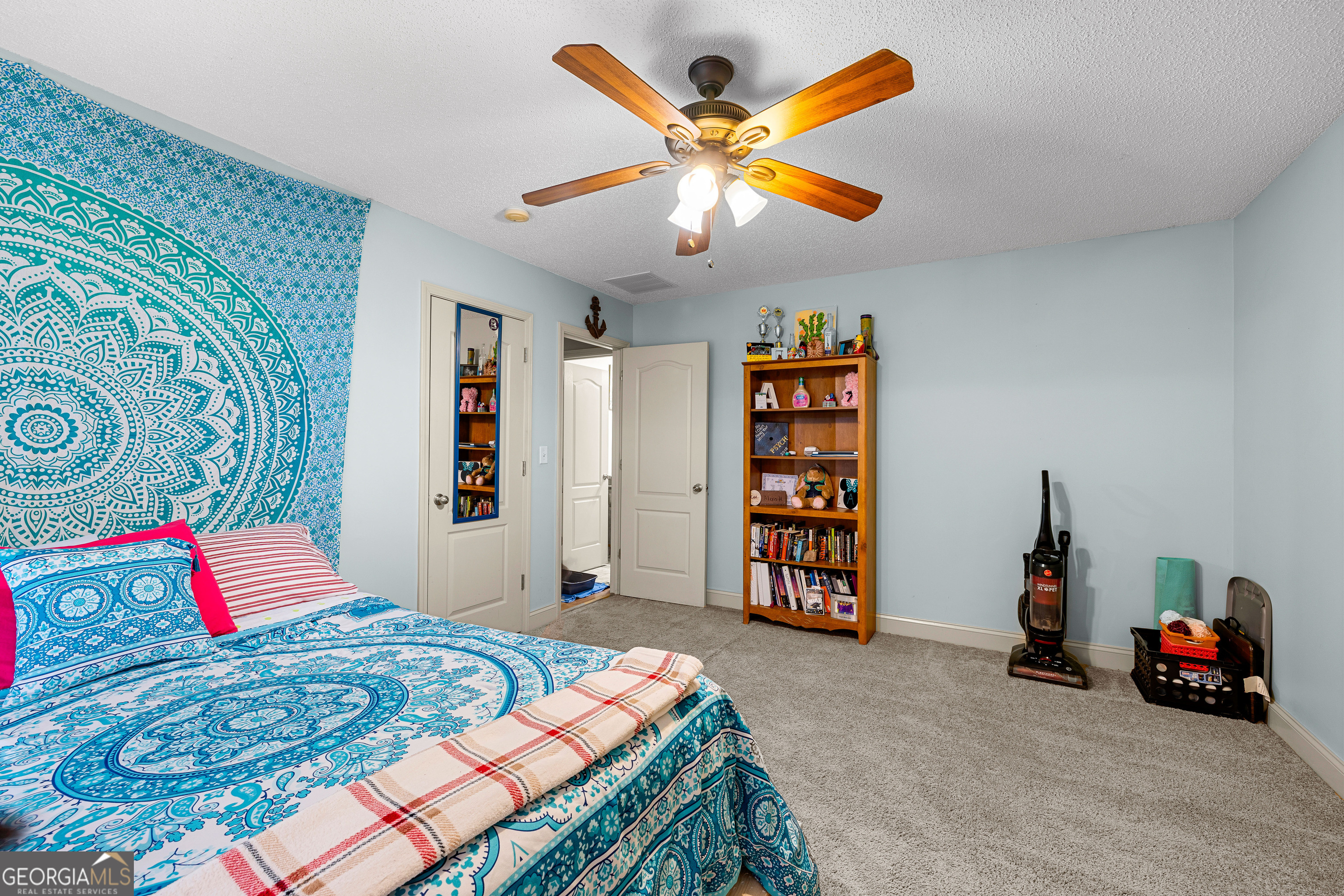 21 Hunters Overlook Drive Senoia, GA 30276 - Photo 21 of 37 a bedroom with a bed and a bookshelf