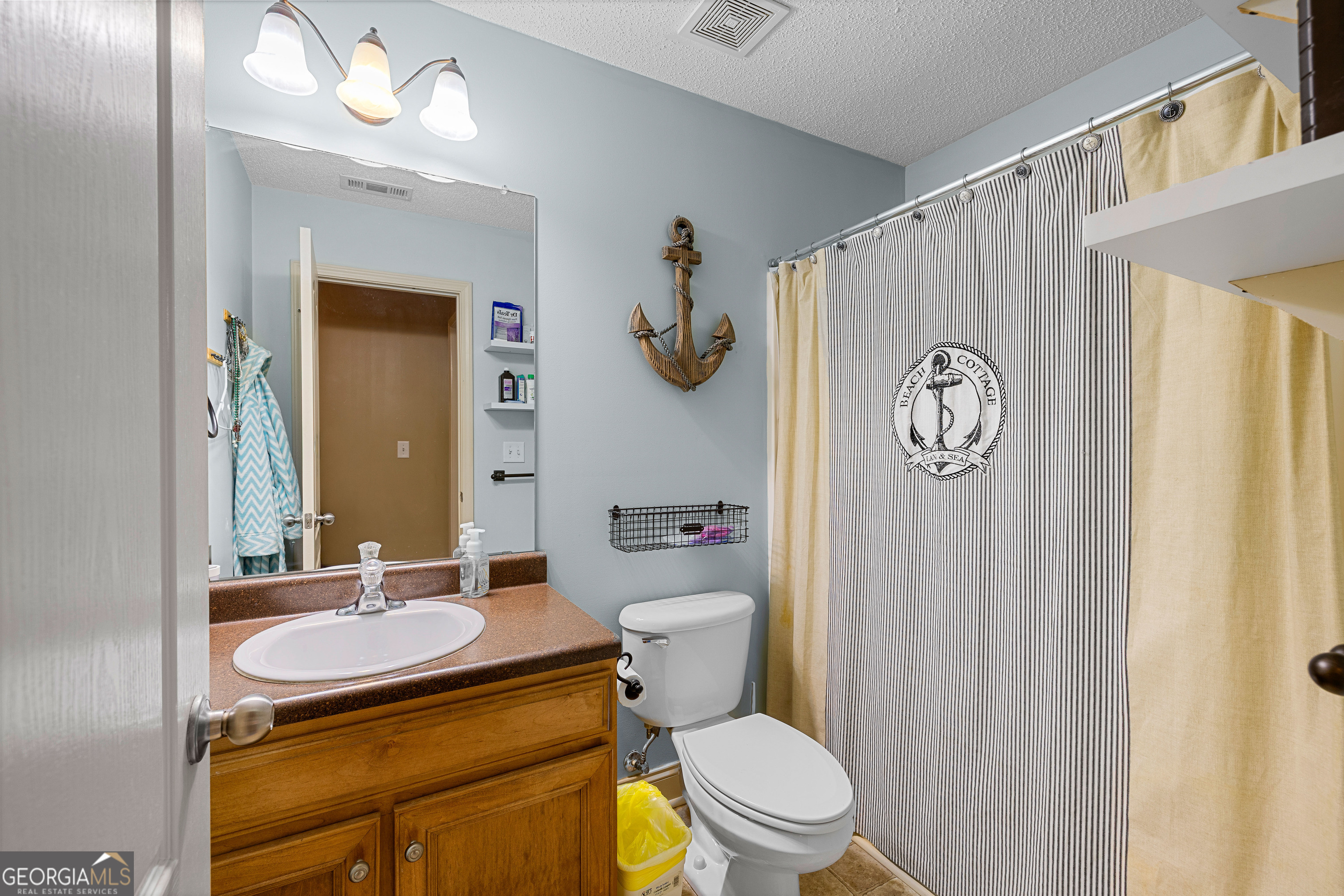 21 Hunters Overlook Drive Senoia, GA 30276 - Photo 22 of 37 a bathroom with a granite countertop toilet sink and mirror