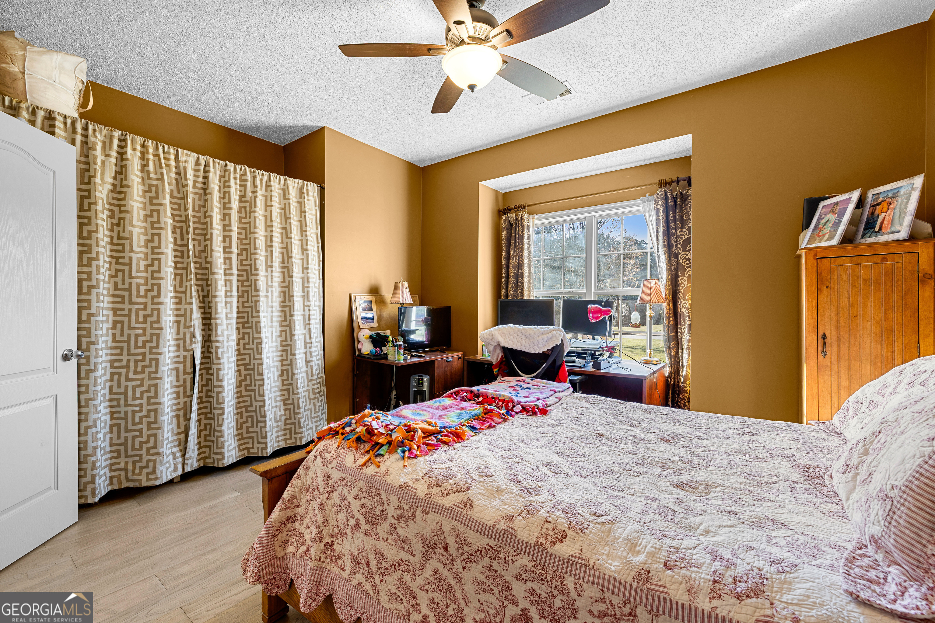 21 Hunters Overlook Drive Senoia, GA 30276 - Photo 27 of 37 a bedroom with a bed and wooden floor