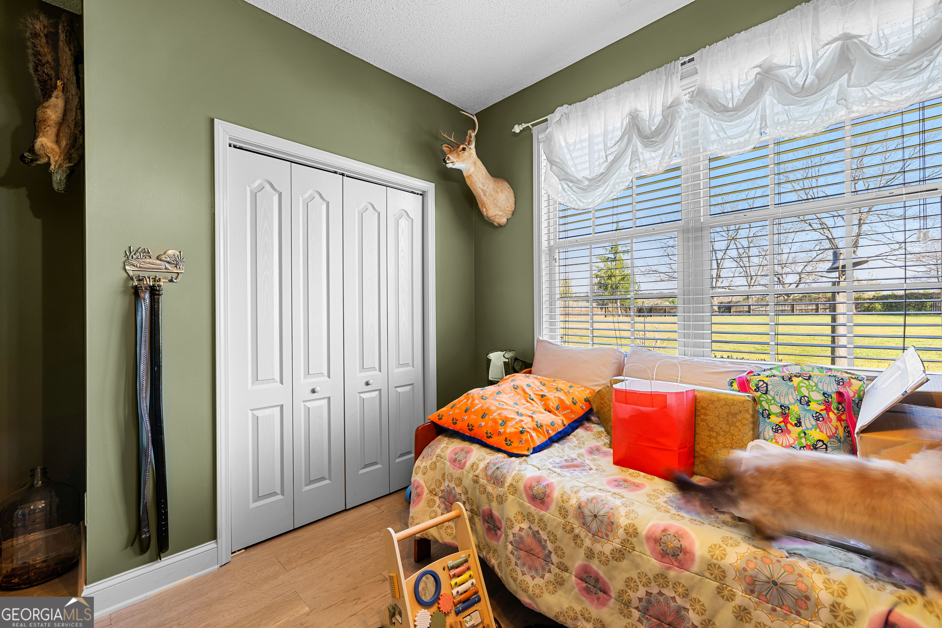 21 Hunters Overlook Drive Senoia, GA 30276 - Photo 29 of 37 a bed sitting in a bedroom next to a window